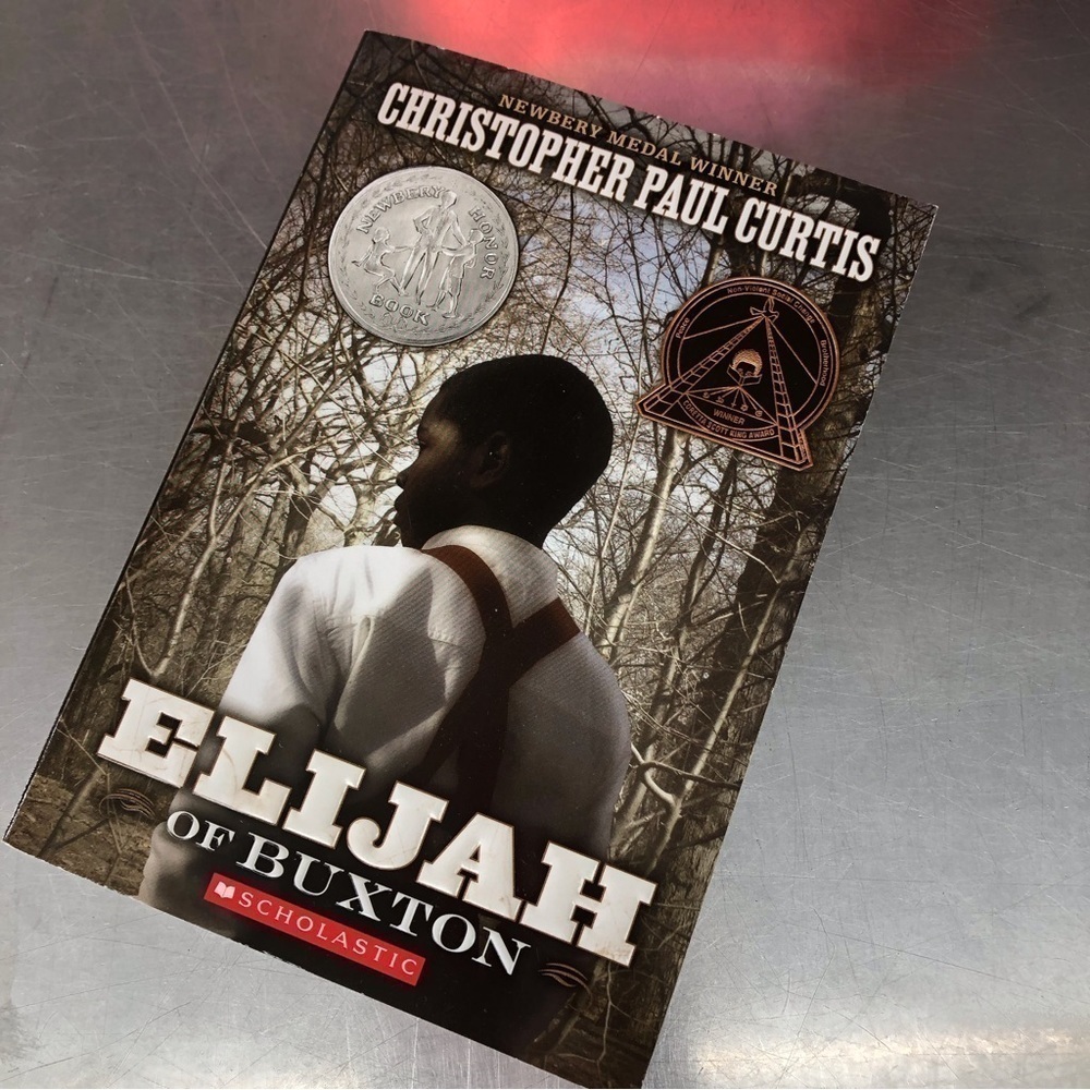 Elijah of Buxton by: Christopher Paul Curtis, paperback book